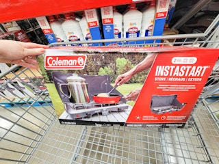 hand holding a coleman 2 burner camp stove in a cart