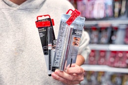 person holding loreal eyeliner and mascara