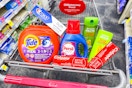 tide pods, crest and colgate toothpaste, persil detergent, and garnier shampoo in a cart