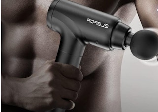 a person holding a massage gun