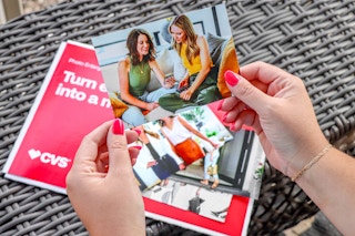 hand holding cvs photo prints with heather and joanie