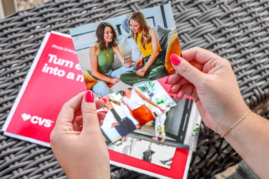 hand holding cvs photo prints with heather and joanie