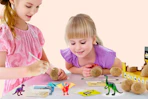 Lifestyle image of a Dinosaur Egg Excavation Kit at Walmart (2 girls playing with it)