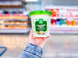 hand holding a tub of members mark jalapeno feta dip