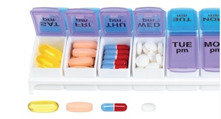 Purple and blue pill organizer with pills