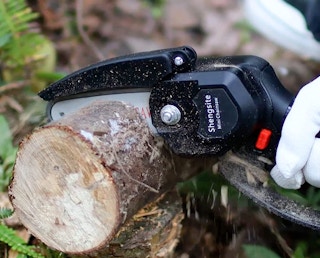 mini chainsaw cutting a log