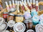 basket of yankee candle room spray and single- and three-wick candles in store