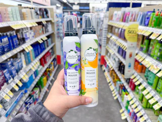 hand holding herbal essences mousse in walgreens