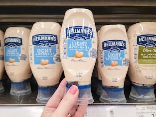 hand holding a bottle of hellmanns mayo at kroger
