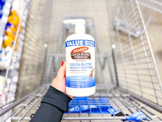 Palmers Cocoa Butter Lotion held over Walmart shopping cart