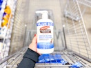 Palmers Cocoa Butter Lotion held over Walmart shopping cart