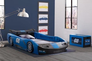 lifestyle image of a childrens bedroom with a race car bed