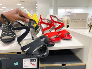 hand holding evening shoes