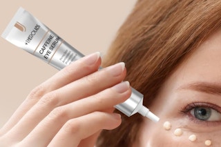 a woman using caffeine eye cream