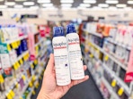 hand holding aquaphor ointment spray in cvs