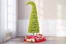 Lifestyle image of the Holiday Time Lawndale Spruce Tree in home setting near window