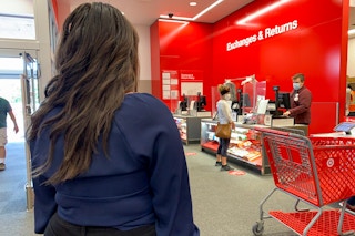 A woman standing in line at the Target return counter.