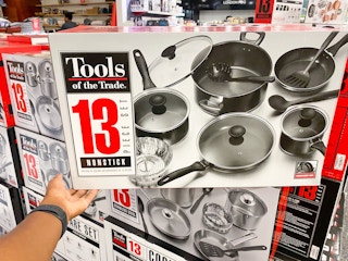 someone holding a 13-piece cookware set