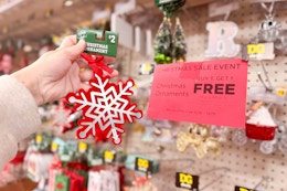 hand holding up a christmas ornament