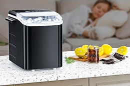 Lifestyle image of the EDX Countertop Ice Maker on counter with person sleeping in the background