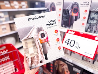hand holding a brookstone heated blanket at target