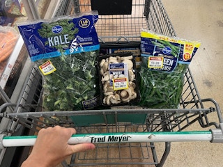 Manager Special tags on bags of chopped kale, mushroom, green beans
