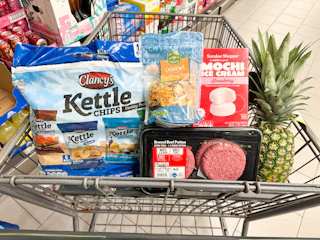 chips, cashews, beef patties, pineapple, and mochi ice cream in a cart