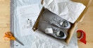 shoes in box with return label scissors and packing tape