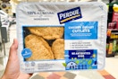 hand holding a pack of perdue chicken