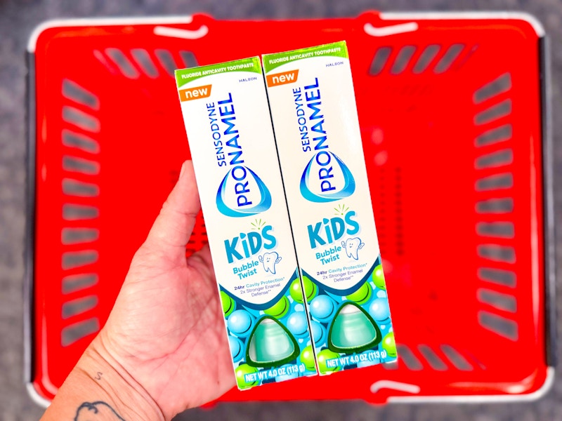 hand holding two sensodyne kids toothpastes