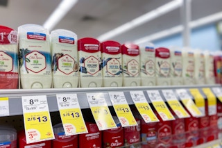 a shelf with sale tags and old spice deodorant sticks