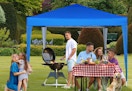 blue canopy tent with people under it at a party