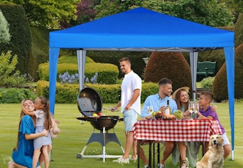 blue canopy tent with people under it at a party