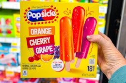 hand holding a box of popsicle ice pops