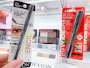 A Revlon eye liner package held out by hand in front of a Revlon eyeshadow and mascara.