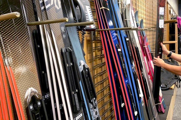 Person looking at skis at REI 