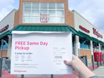 hand holding walgreens photo order in front of walgreens store