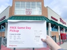 a person holding a photo prints package in hand in front of walgreens