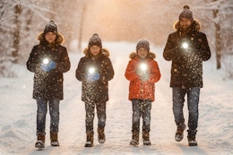 a family walking with flashlights