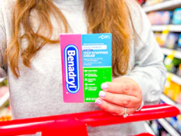 hand holding a benadryl anti-itch cream at target