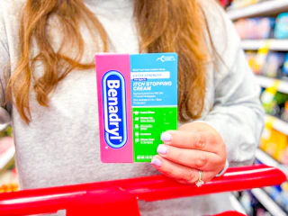 hand holding a benadryl anti-itch cream at target