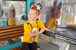 a child riding the disney skyliner at disney world