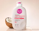 a bottle of lotion next to a coconut