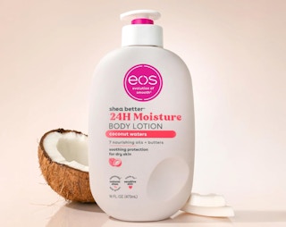 a bottle of lotion next to a coconut