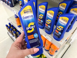 hand holding a bottle of coppertone sunscreen at target
