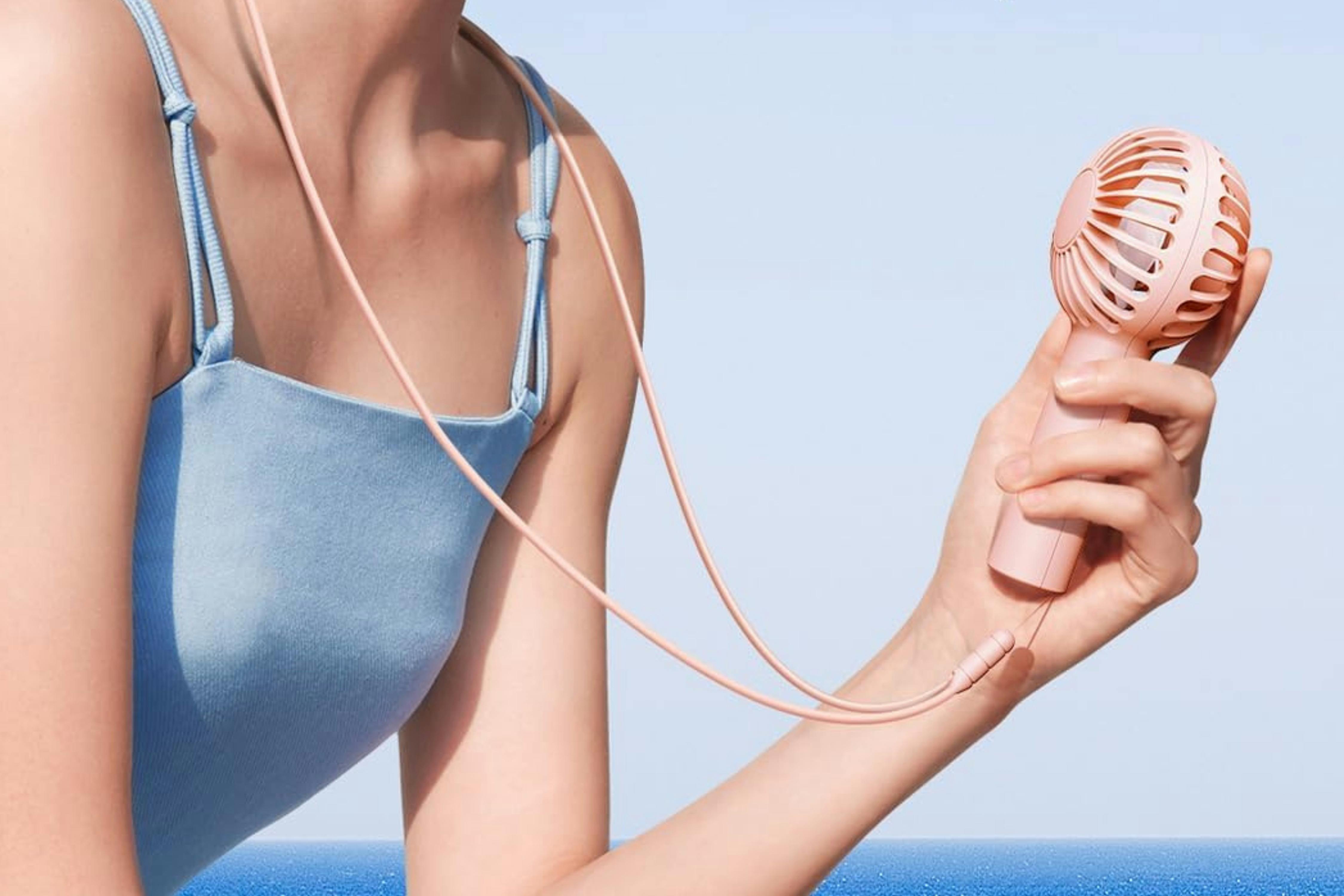 a woman holding a fan