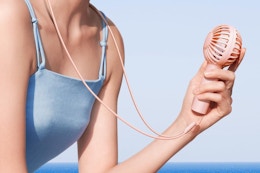 a woman holding a fan
