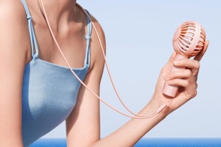 a woman holding a fan