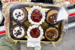 hand holding a pack of members mark mini assorted pies