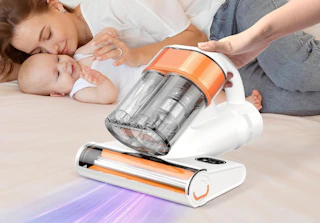 a person using a mattress vacuum next to a mom and baby
